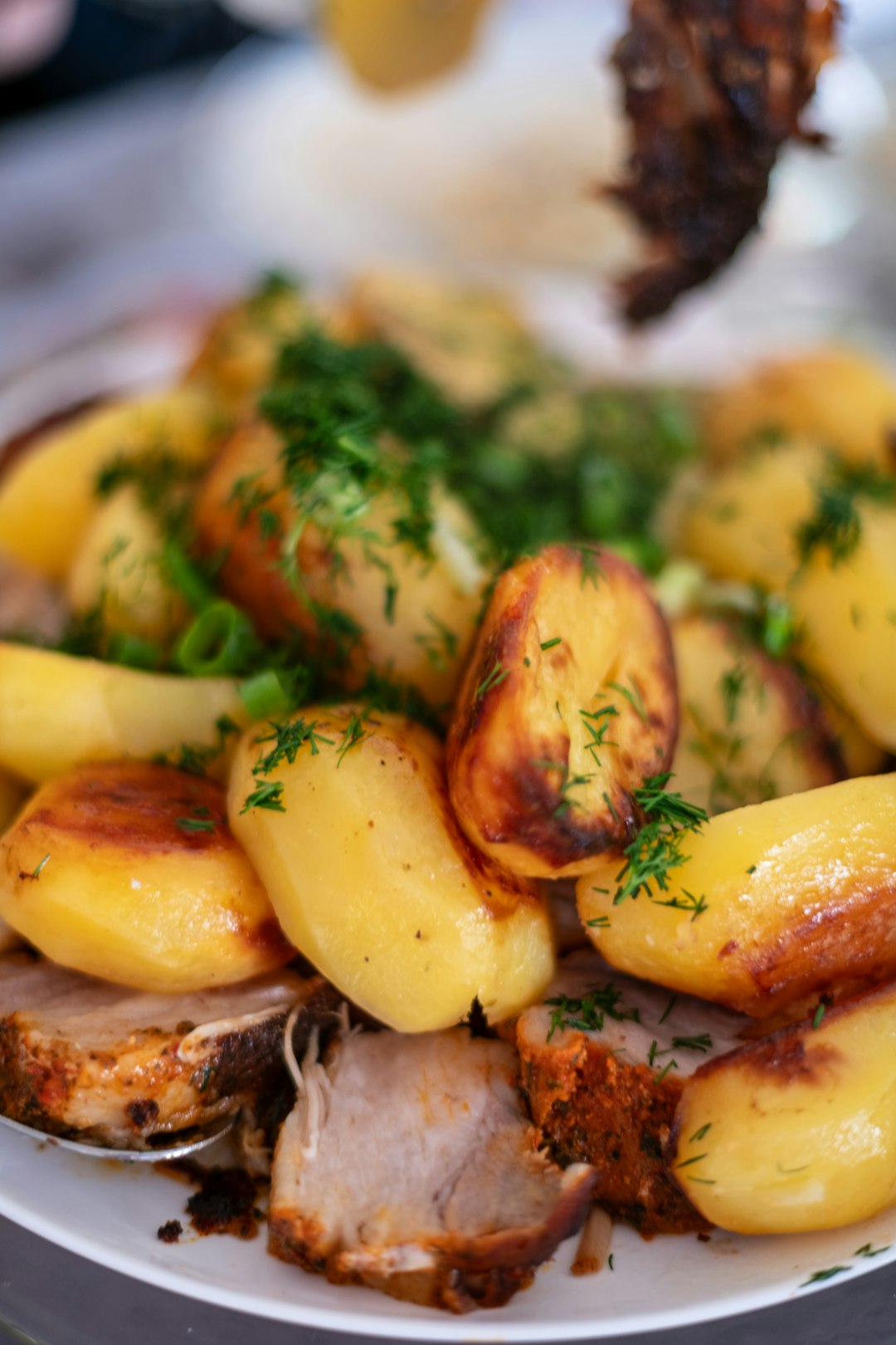 roasted-pork-and-potatoes-with-fresh-dill-garnish-vumecd5lajm